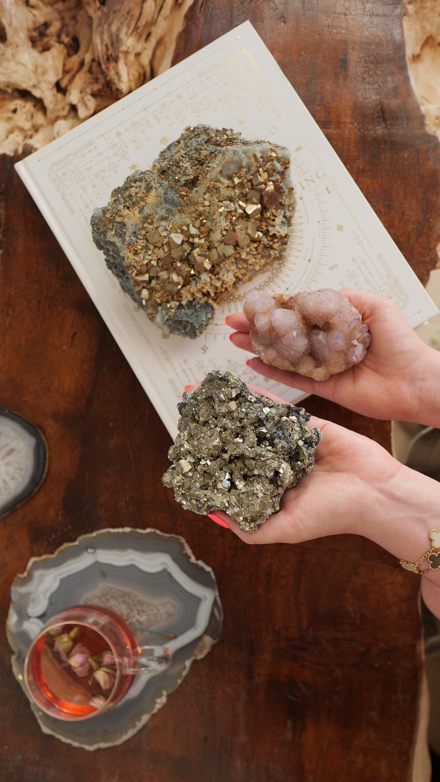 a hand holding a pyrite crystal