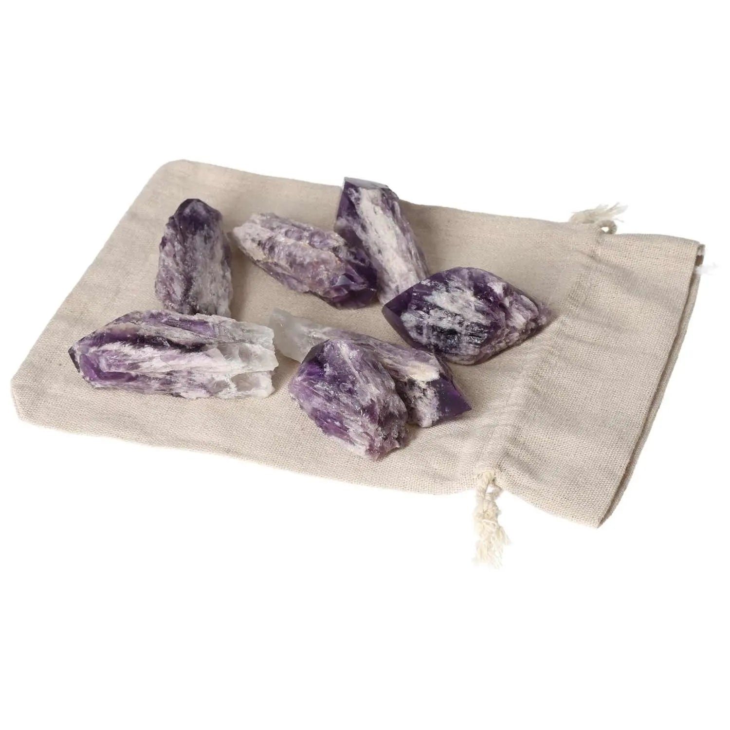 Premium Amethyst Point M crystals on a beige cloth, known for reducing stress and enhancing energy, handpicked by Sylvia Crystals.