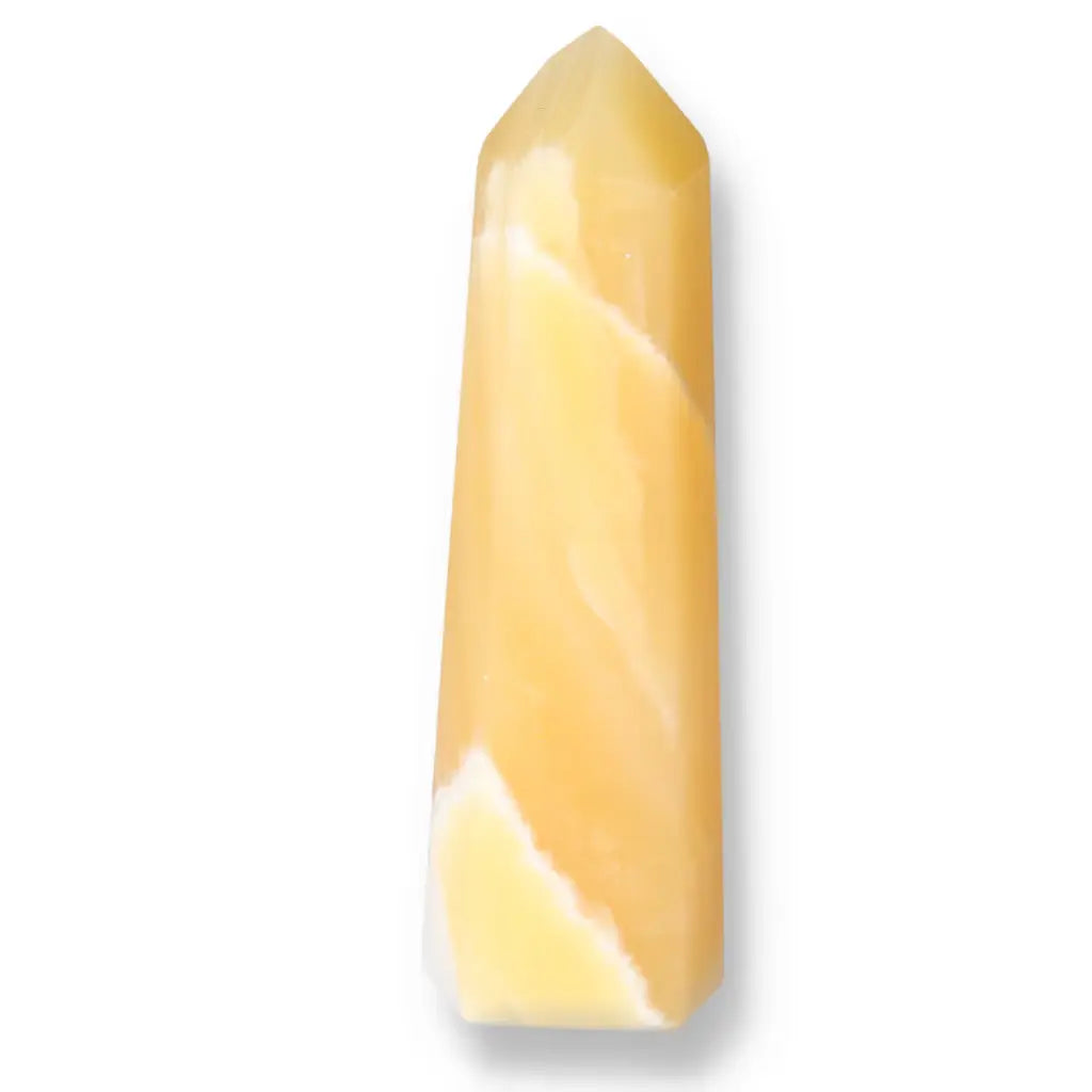 Mexican Calcite Obelisk from Sylvia Crystals, enhancing self-confidence and motivation, in warm yellow tones symbolizing luxury and spirituality.