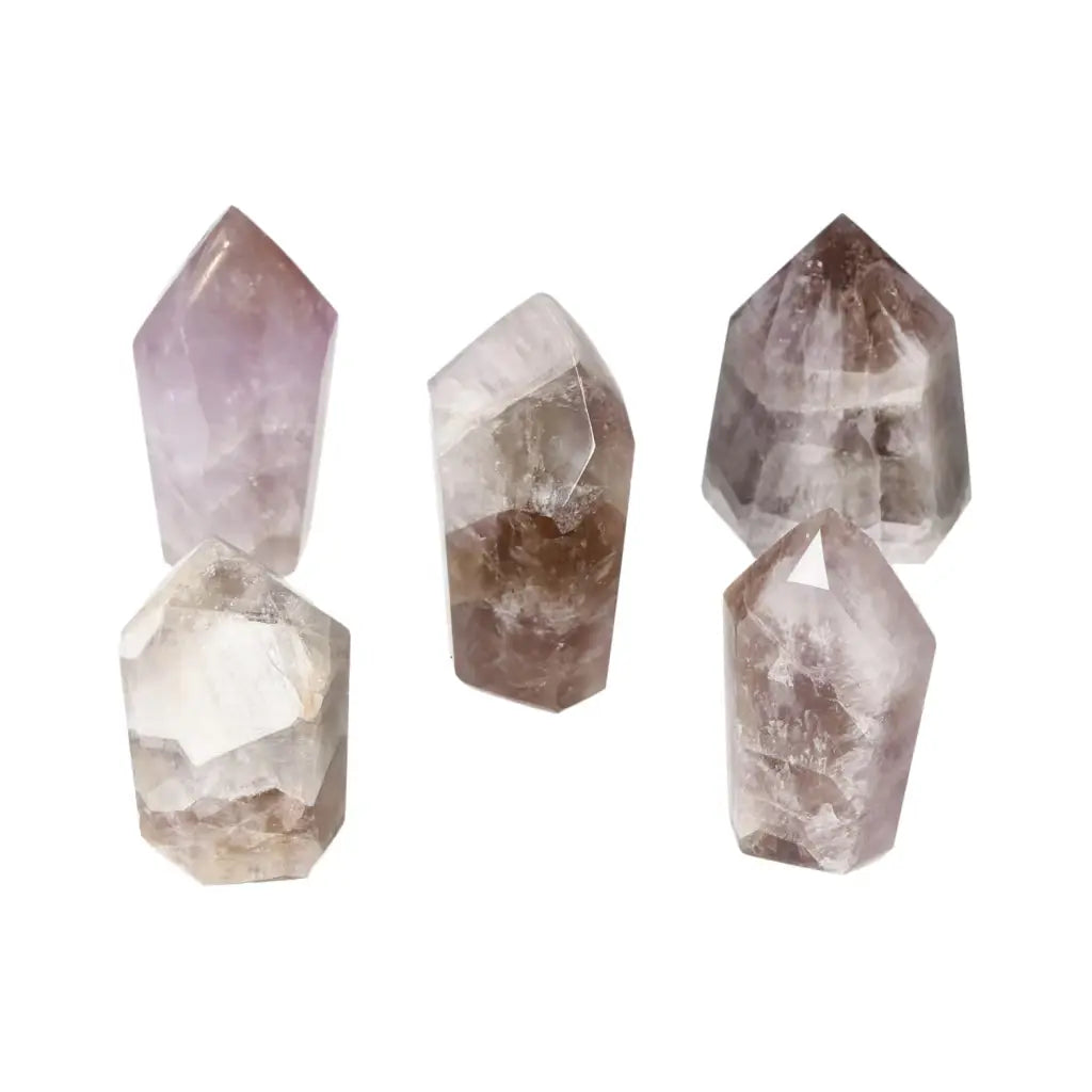Five polished amethyst crystals from Sylvia Crystals, offering tranquility and energy boost, displayed on a white background.