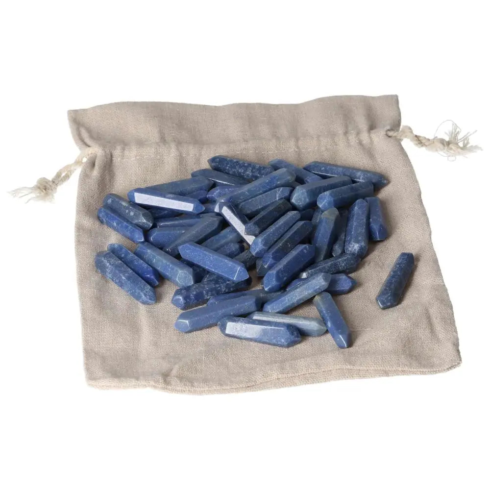 Blue Aventurine small sticks on a beige cloth bag, known for mystical properties aiding personal transformation and spiritual growth.