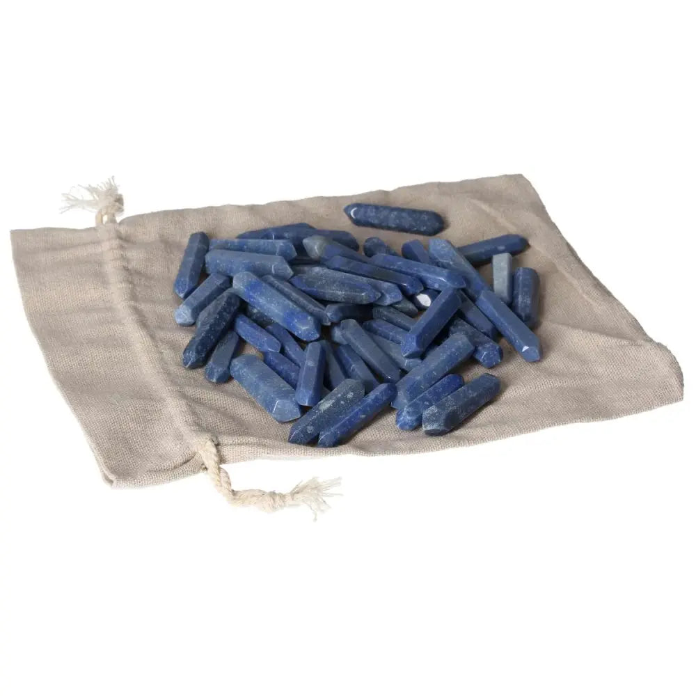 Blue Aventurine small sticks on beige cloth, ideal for spiritual transformation and awakening, with mystical properties.