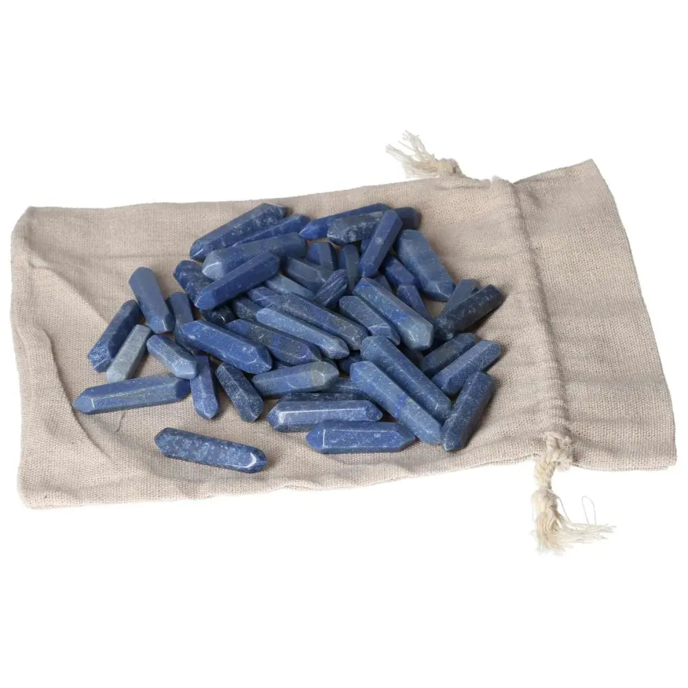 Blue Aventurine small sticks on a beige fabric pouch, ideal for spiritual transformation and awakening, showcasing mystical properties.
