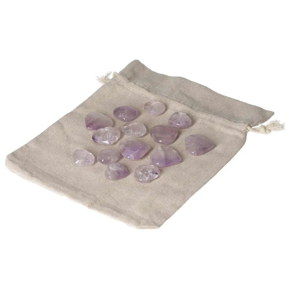 Amethyst small heart stones on a cloth bag, ideal for stress reduction, energy boost, and emotional stability; enhances concentration.