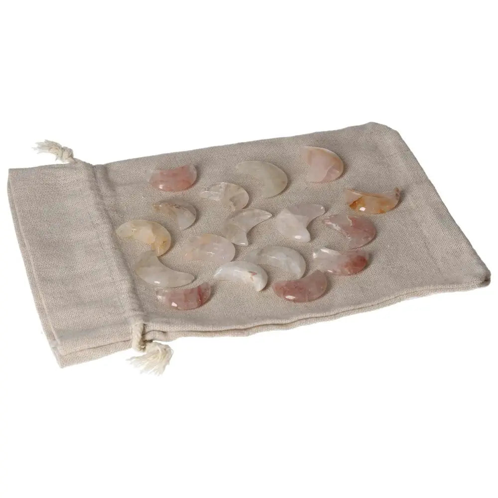 Handcrafted Golden Healer moon-shaped stones in a drawstring pouch, perfect for healing and meditation practices.