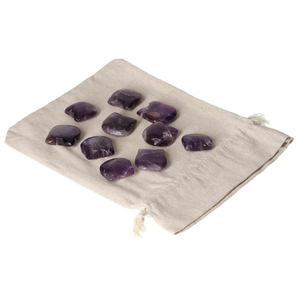 Amethyst Small Cat stones on a beige pouch, known for reducing stress, boosting energy, enhancing concentration, and emotional stability.