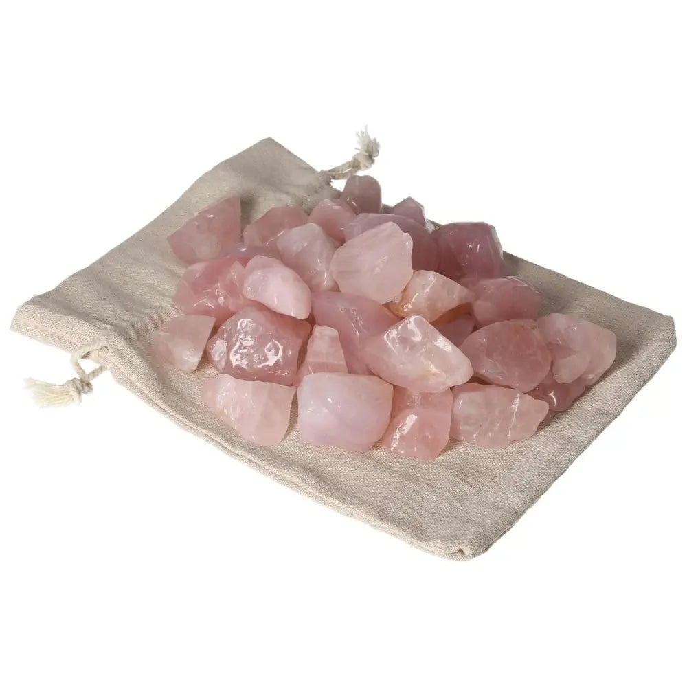 Tumbled Rose Quartz stones on a fabric pouch, promoting emotional healing and harmony by Sylvia Crystals.