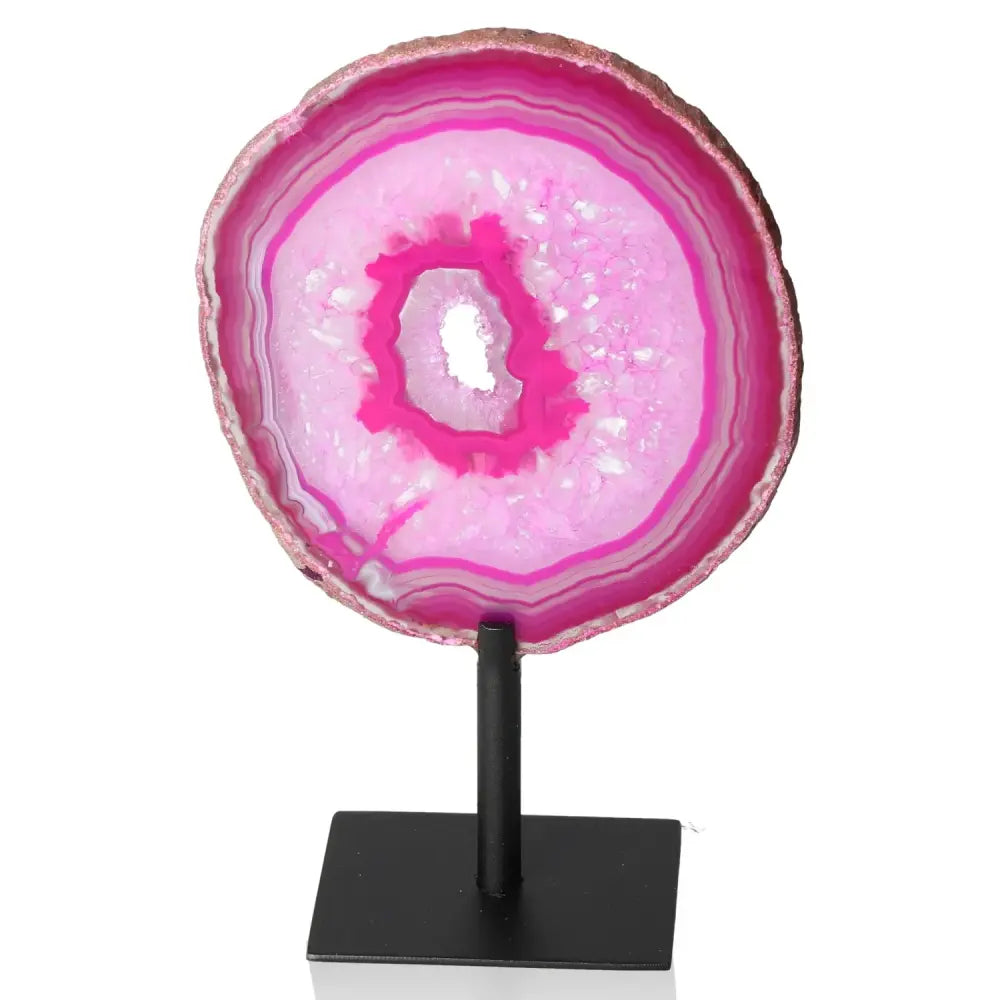 Pink agate slice on a metal stand showcasing vibrant natural bands and colors, ideal for home decor and enhancing tranquility and balance.