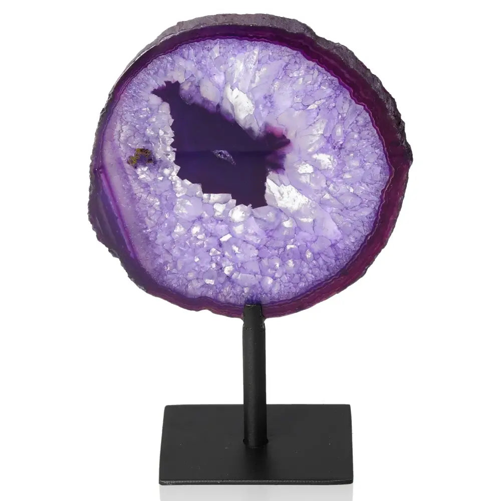 Vibrant purple agate slice on sleek metal stand showcasing nature's artistry in home decor.