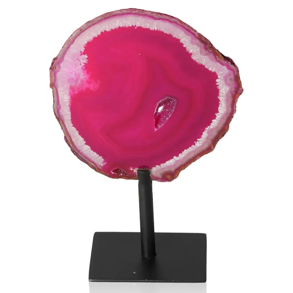 Vibrant pink agate slice on a sleek metal stand, perfect for adding color and tranquility to any space.