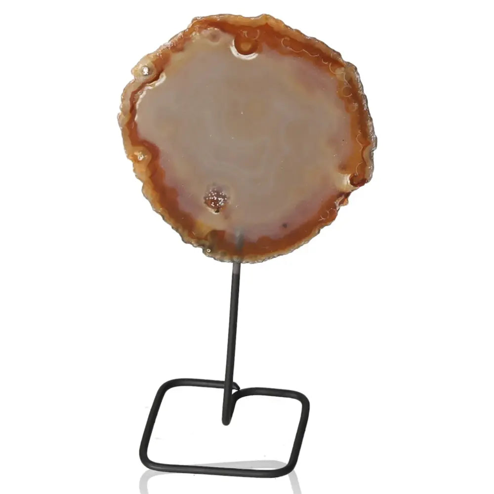 Agate slice on a metal stand, offering elegance and tranquility for home or office decor.