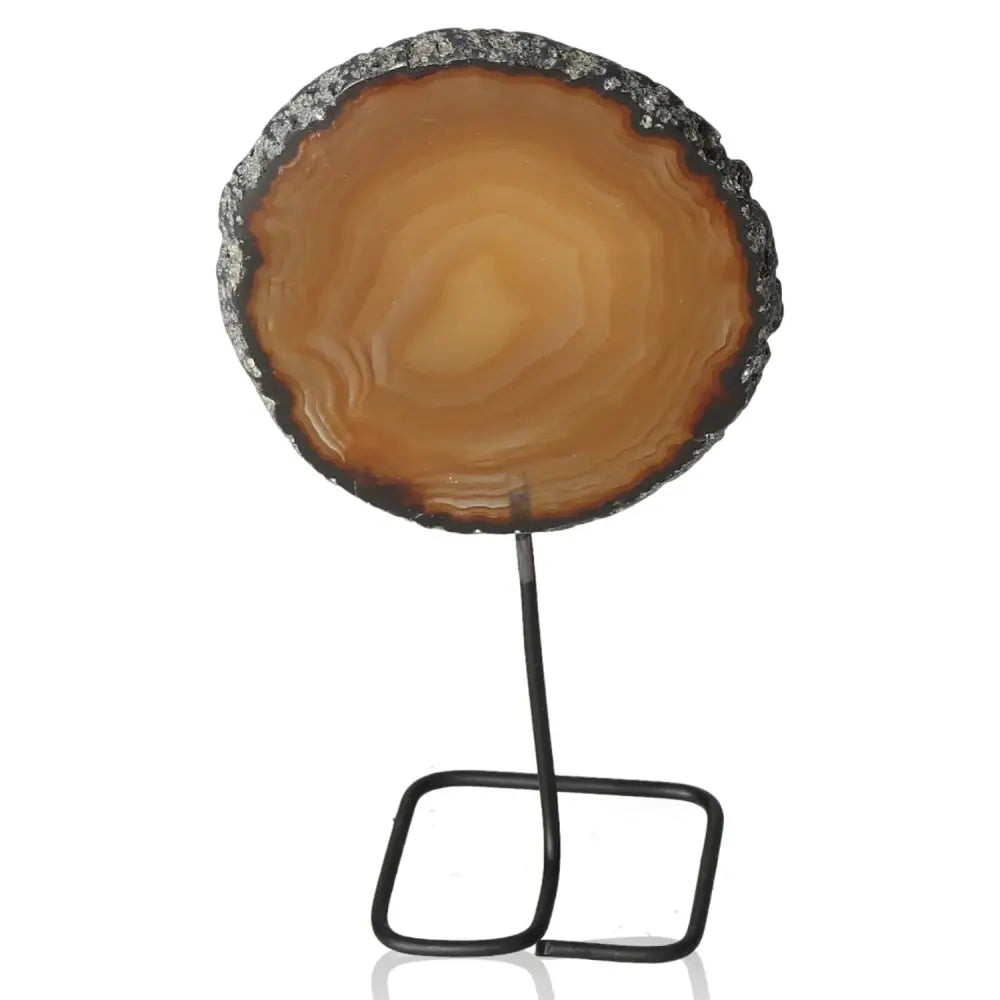 Natural agate slice on sleek metal stand, showcasing elegance and tranquility, perfect for home decor and creating a serene ambiance.
