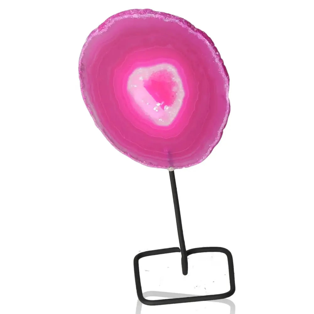 Pink agate slice on metal stand showcasing natural patterns and vibrant colors, perfect for enhancing home decor and tranquility.