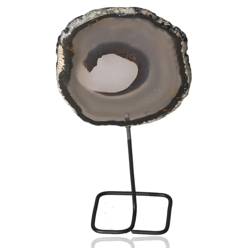Agate slice on metal stand with natural bands and unique patterns, evoking serenity and balance, ideal for home decoration.