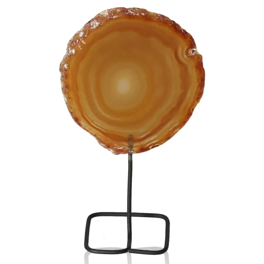Elegant agate slice on a sleek metal stand, harmonizing energy and ambiance with natural beauty and modern elegance.
