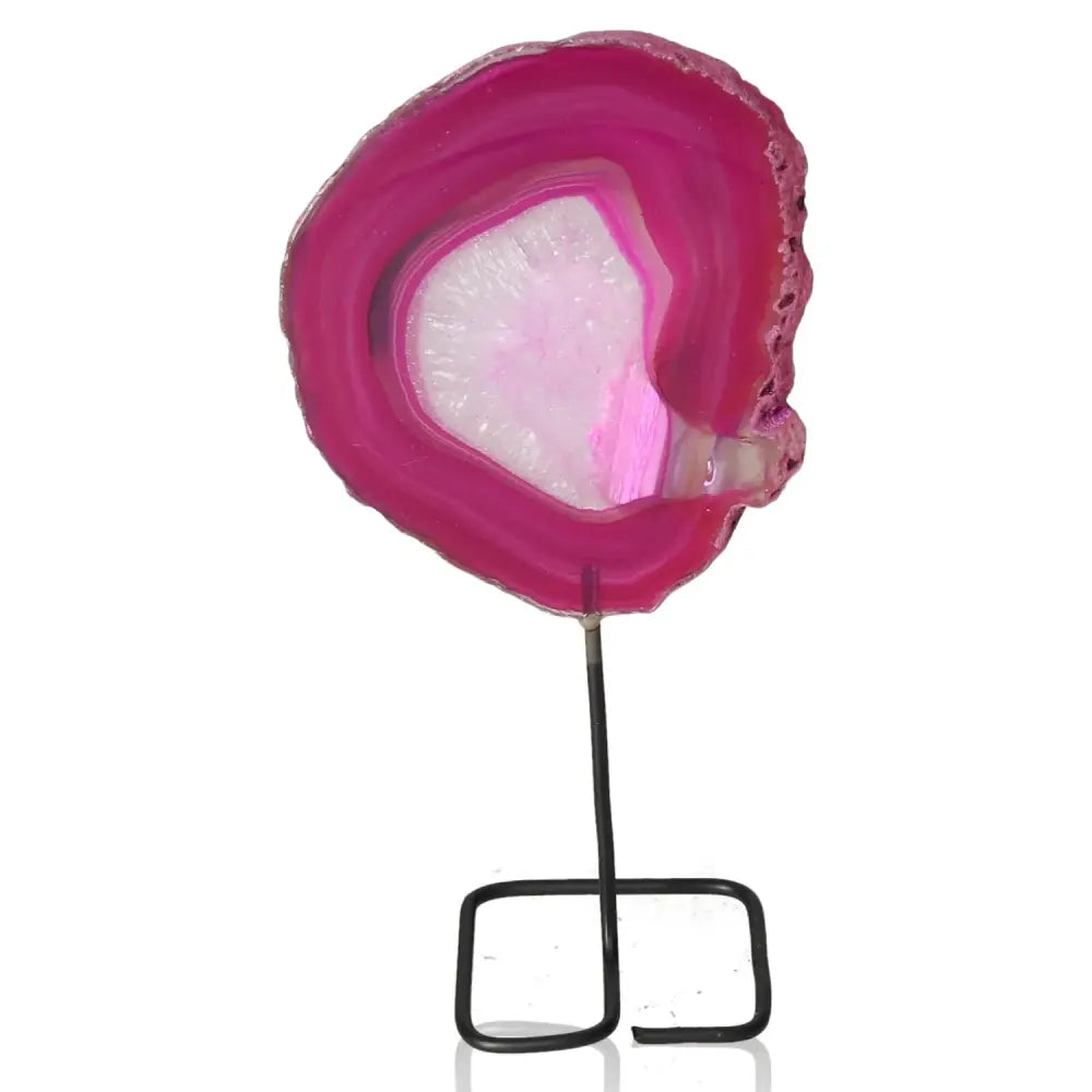 Pink agate slice on metal stand, showcasing natural patterns and vibrant hues, perfect as a centerpiece for modern decor.
