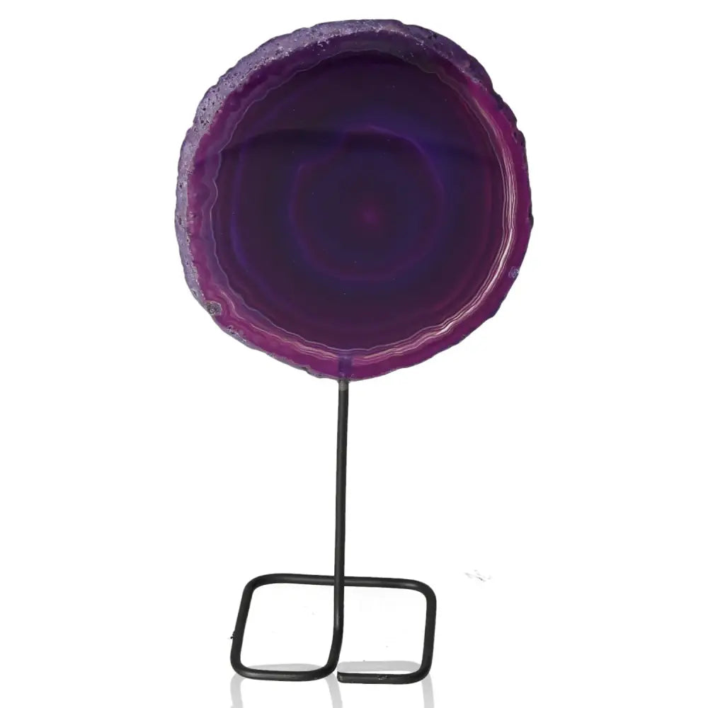 Purple agate slice on a sleek metal stand, highlighting its natural beauty and decorative elegance.