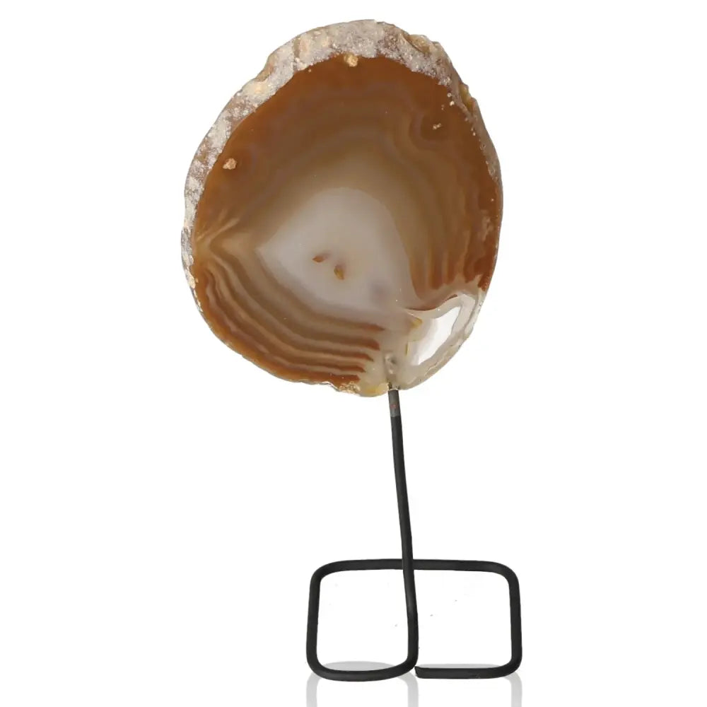 Natural agate slice on a metal stand, showcasing earthy hues and intricate patterns for home or office decor.