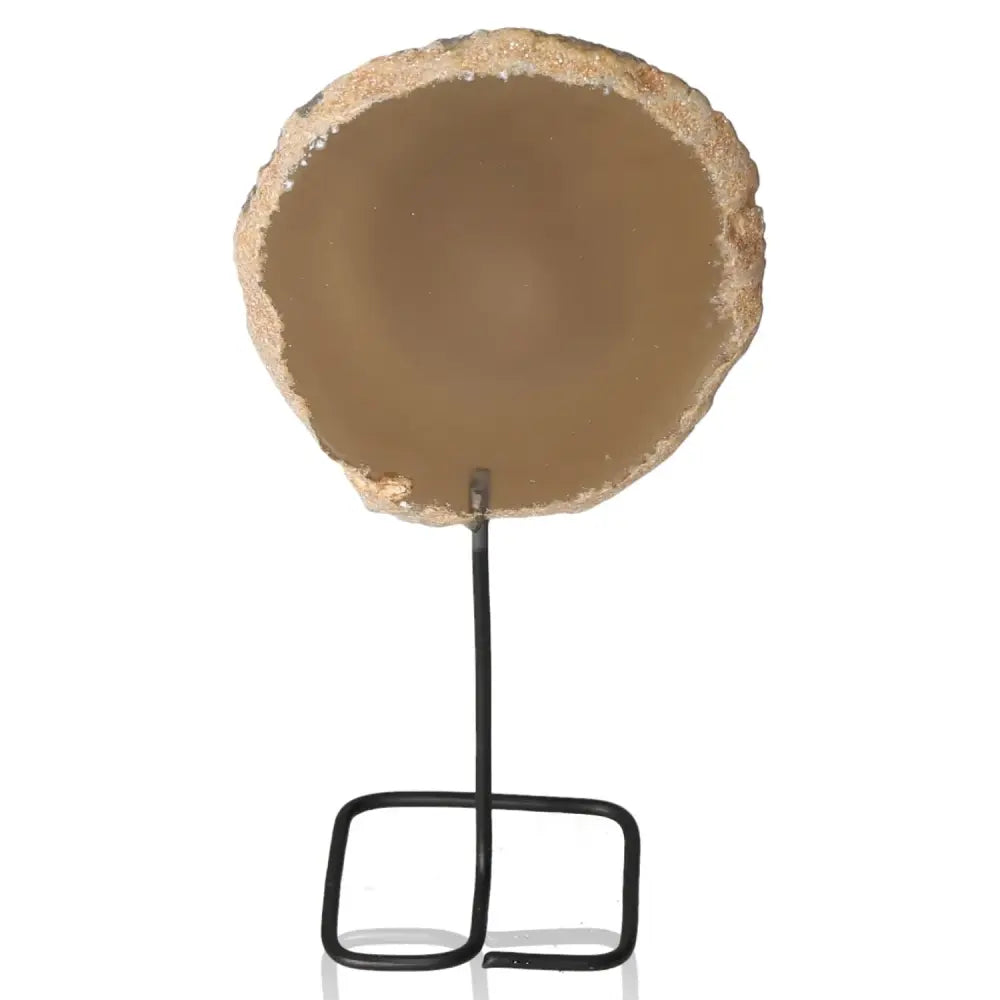 Agate slice displayed on a sleek metal stand, showcasing natural beauty and calming energy for home decor.
