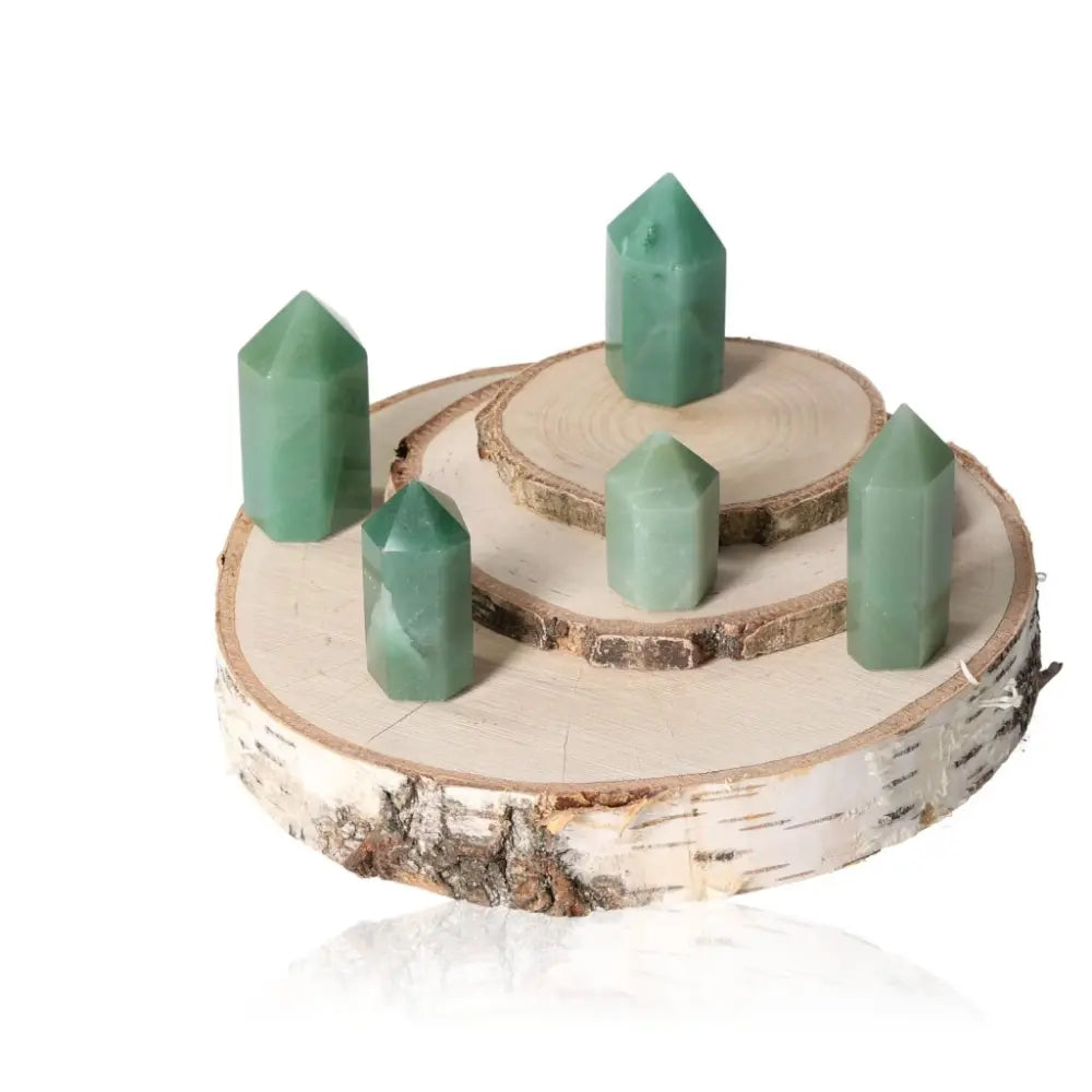 Green Quartz Obelisks on wooden display, enhancing personal growth and emotional balance through heart chakra resonance.
