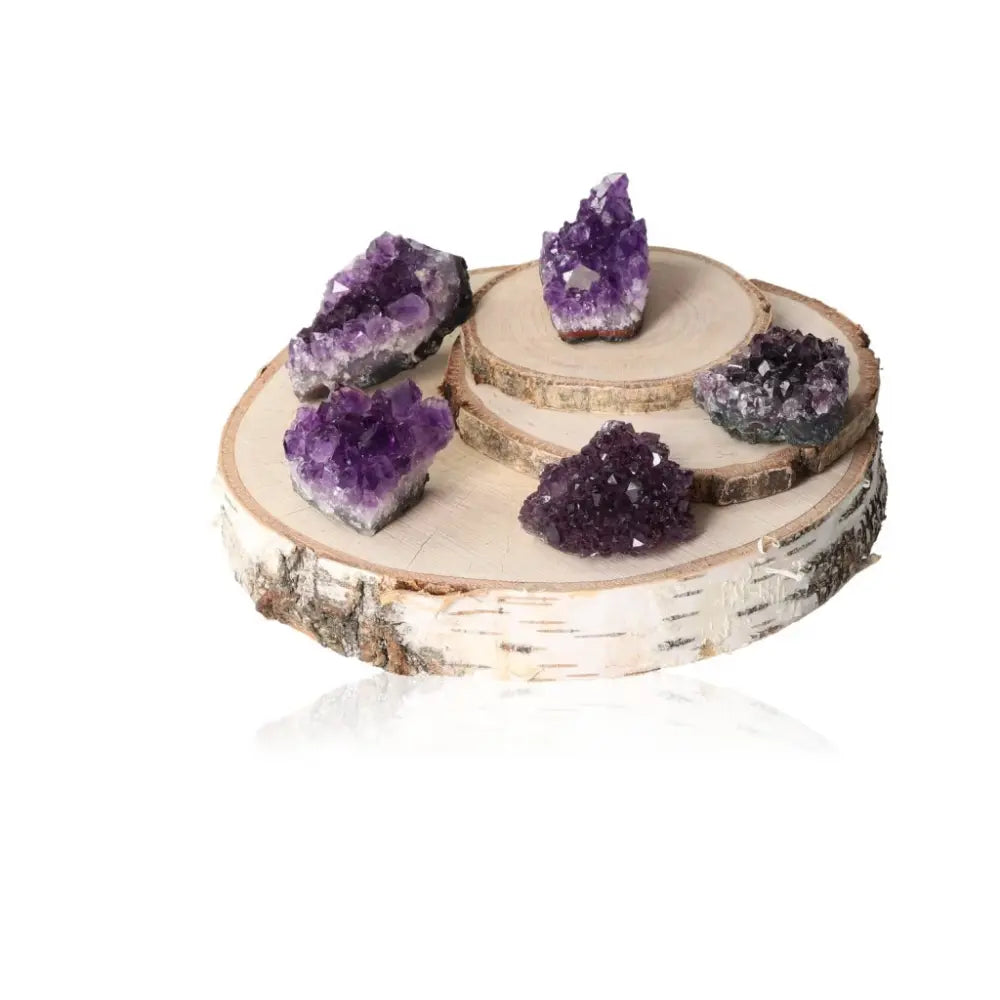 Collection of Amethyst Druze S crystals on wooden stand, showcasing their natural beauty and healing properties.