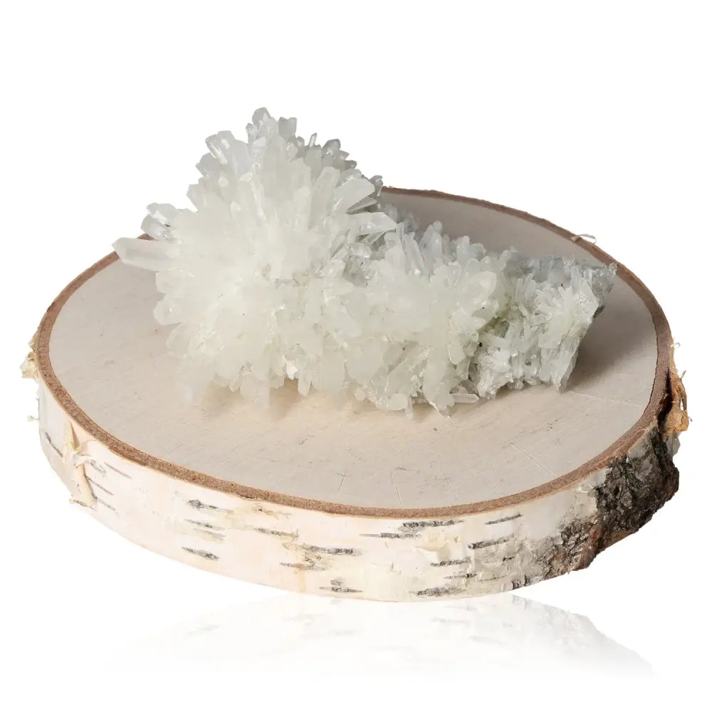 Quartz crystal on a wooden slab, showcasing its clear, glass-like formations ideal for meditation and spiritual exploration.