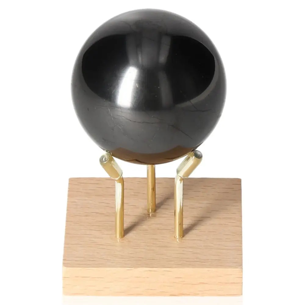 Shungite Sphere 5 cm on stand, luxury Sylvia Crystals product, offers protection and wellness.