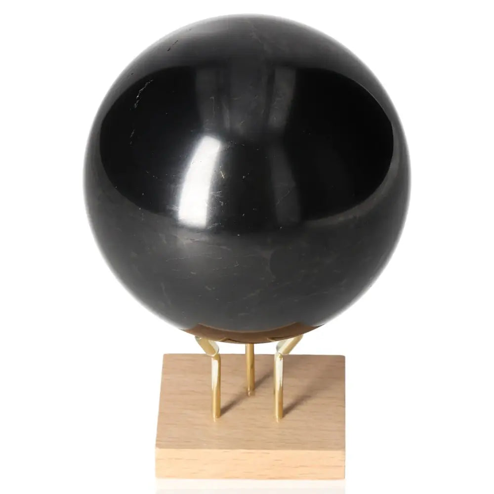 Shungite Sphere 10 cm by Sylvia Crystals, decorative healing orb on stand, enhances space with calming and protective energy