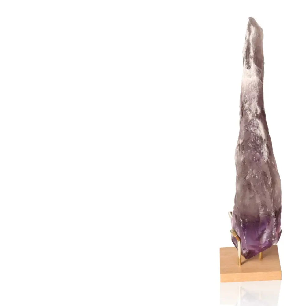 Natural Amethyst Point gemstone with rich purple hues, standing elegantly on a wooden base, ideal for enhancing spiritual growth and tranquility.