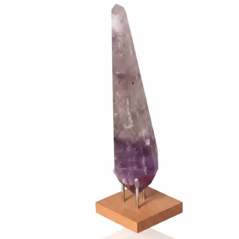 Natural Amethyst Point gemstone on wooden stand, deep purple hues, promotes spiritual enlightenment and chakra balance.