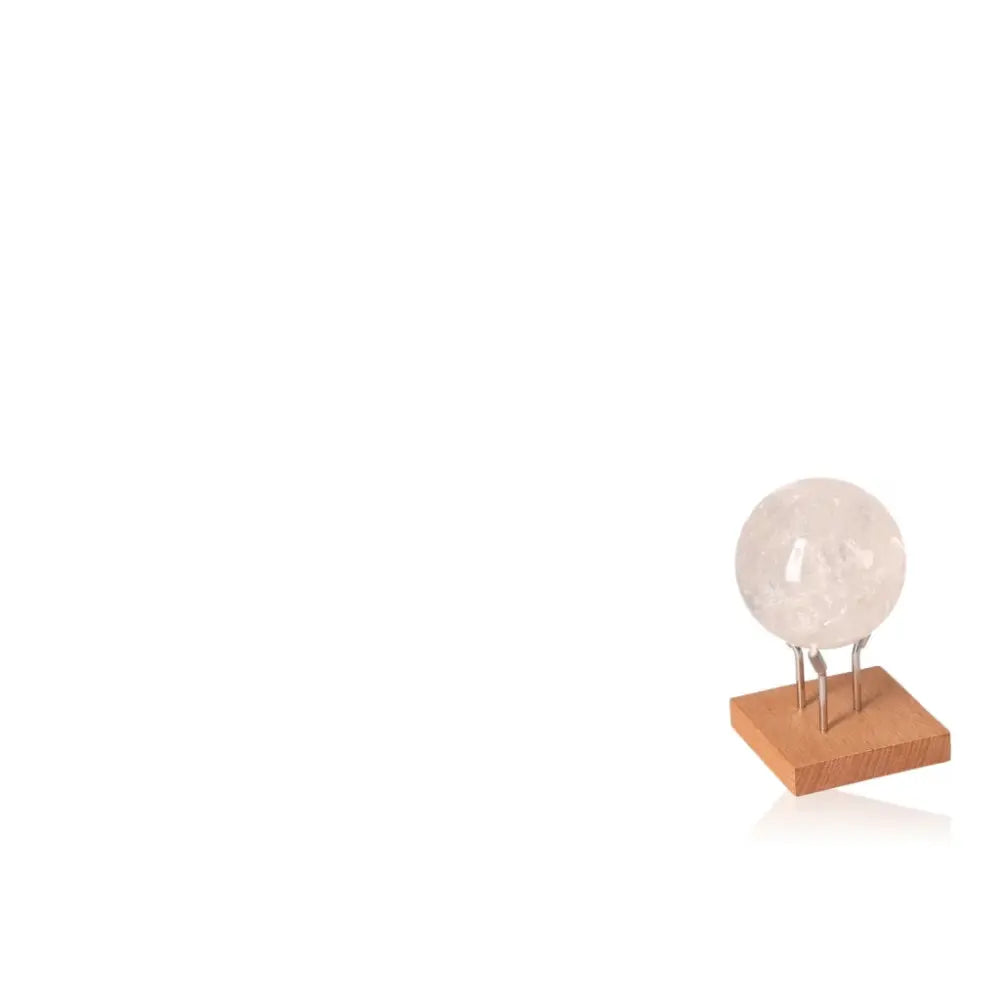 Lemurian Quartz Sphere on wooden stand, showcasing its ethereal beauty and spiritual energy, from Sylvia Crystals.