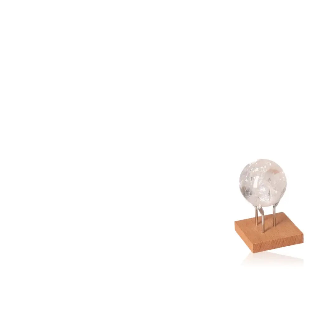 Lemurian Quartz Sphere on wooden stand, enhancing energy and clarity from Sylvia Crystals' premium collection.