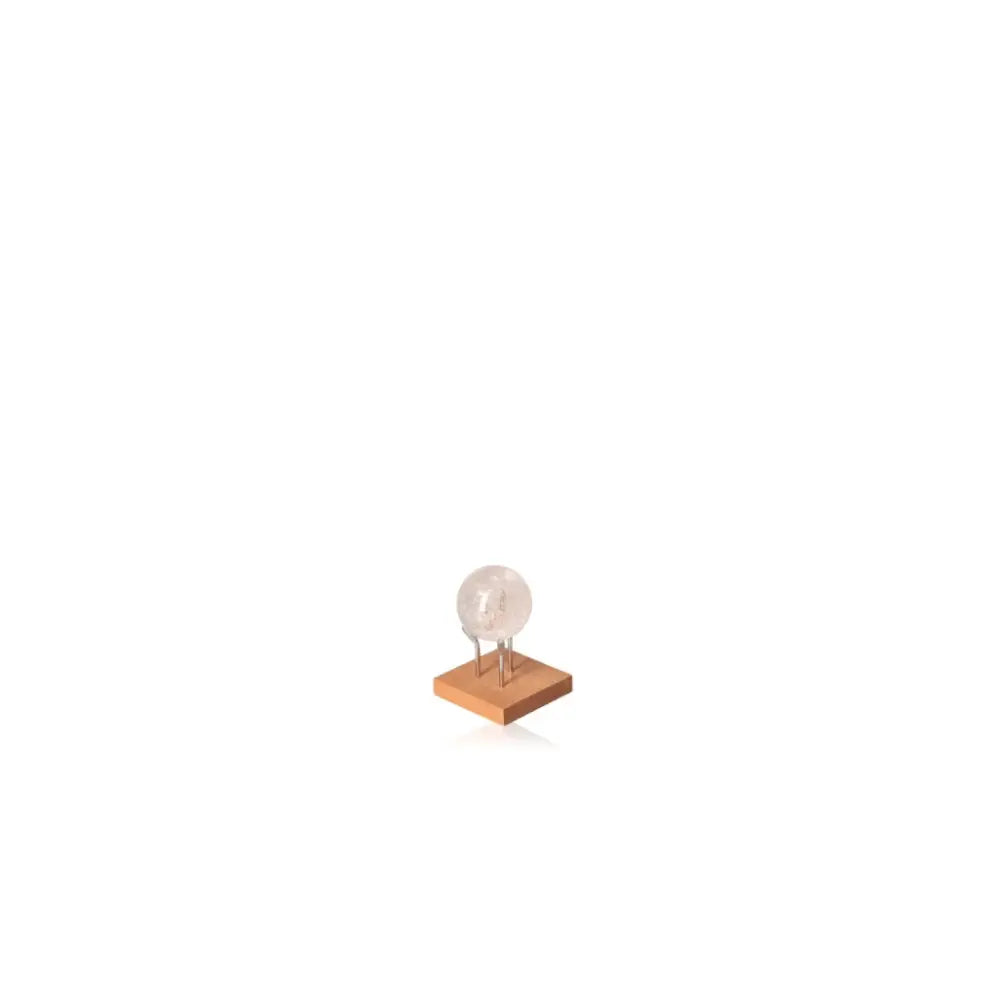 Lemurian Quartz Sphere on wooden stand, symbolizing energy amplification and spiritual connection, perfect for personal transformation.