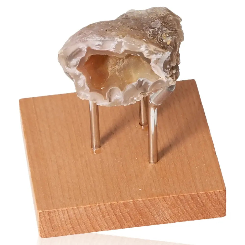 Mini Agate Geode on wooden stand showcasing natural beauty and energy balance qualities.