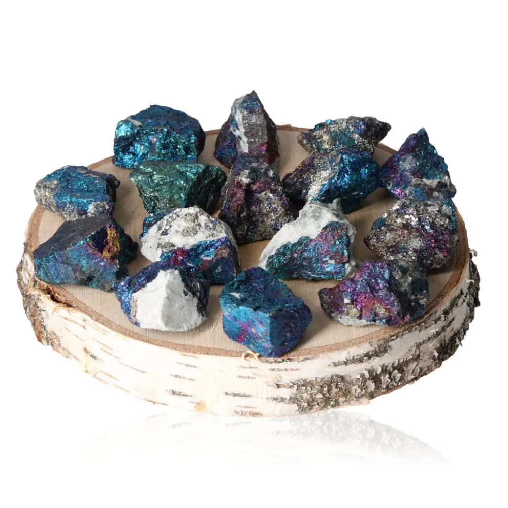 Vibrant colored chalcopyrite crystals displayed on a rustic wooden surface, showcasing their iridescent colors and natural beauty.
