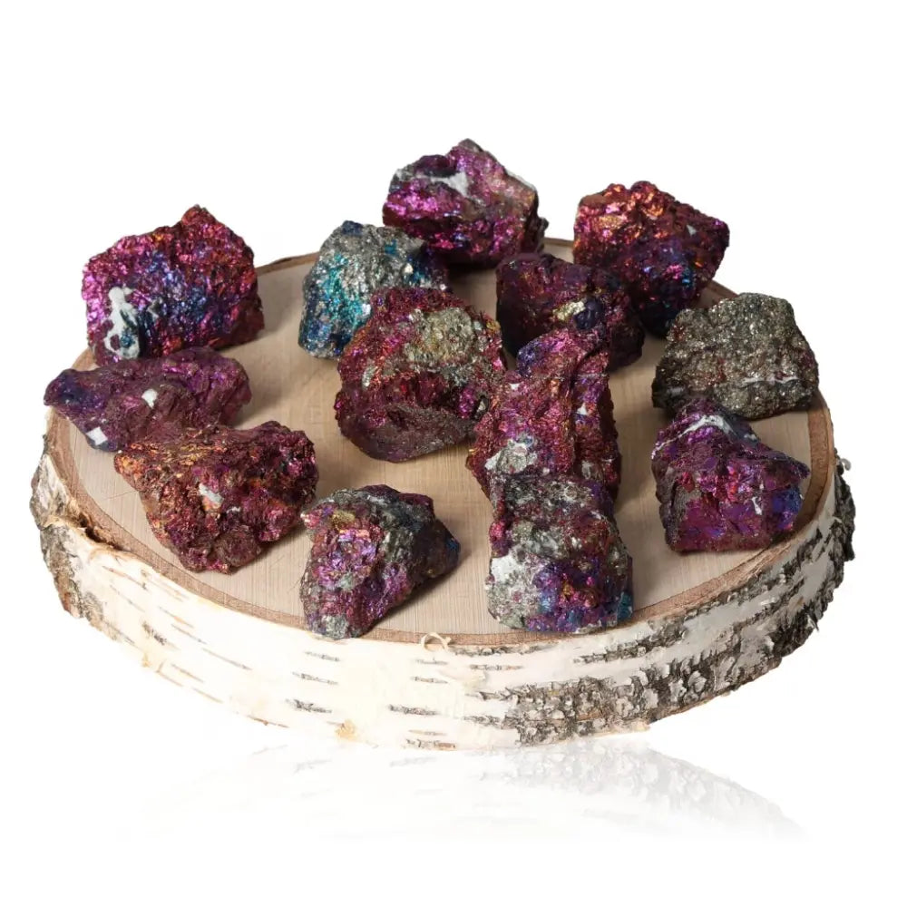Vibrant Colored Chalcopyrite healing crystals displayed on a wooden platform, showcasing their mystical hues for spiritual transformation.