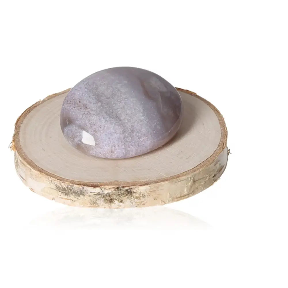 Tumbled Grenatite Chalcedony on wood slice for emotional balance and energy boost