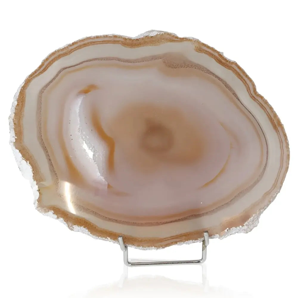 Polished agate slice with swirling brown and cream patterns, symbolizing natural artistry and promoting balance and serenity.
