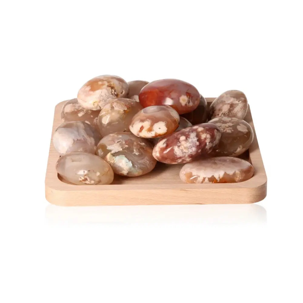 Flower Agate Palm Stones XL on a wooden tray showcasing their natural beauty and transformative properties for emotional well-being.