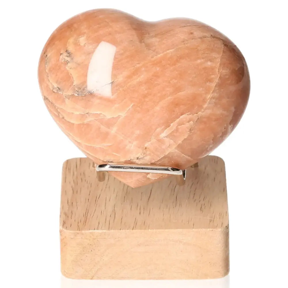 Peach Moonstone Heart for emotional balance and intuition, promotes restful sleep; heart-shaped gemstone, stand not included.