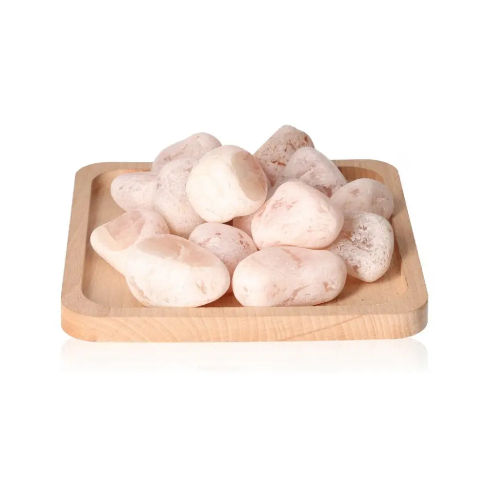 Rose Quartz Emma Eggs displayed on wooden tray, highlighting their gentle, loving energy and exquisite craftsmanship.