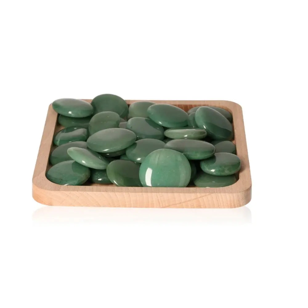 Wooden tray with polished green aventurine palm stones arranged neatly for display.
