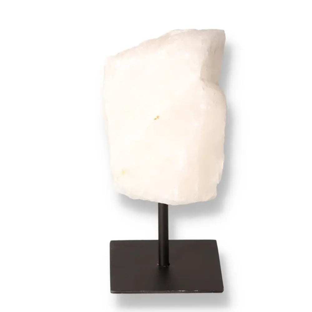 Cut Milky Quartz on metal stand showcasing cloudy opacity, ideal for spiritual and decorative use by Sylvia Crystals.