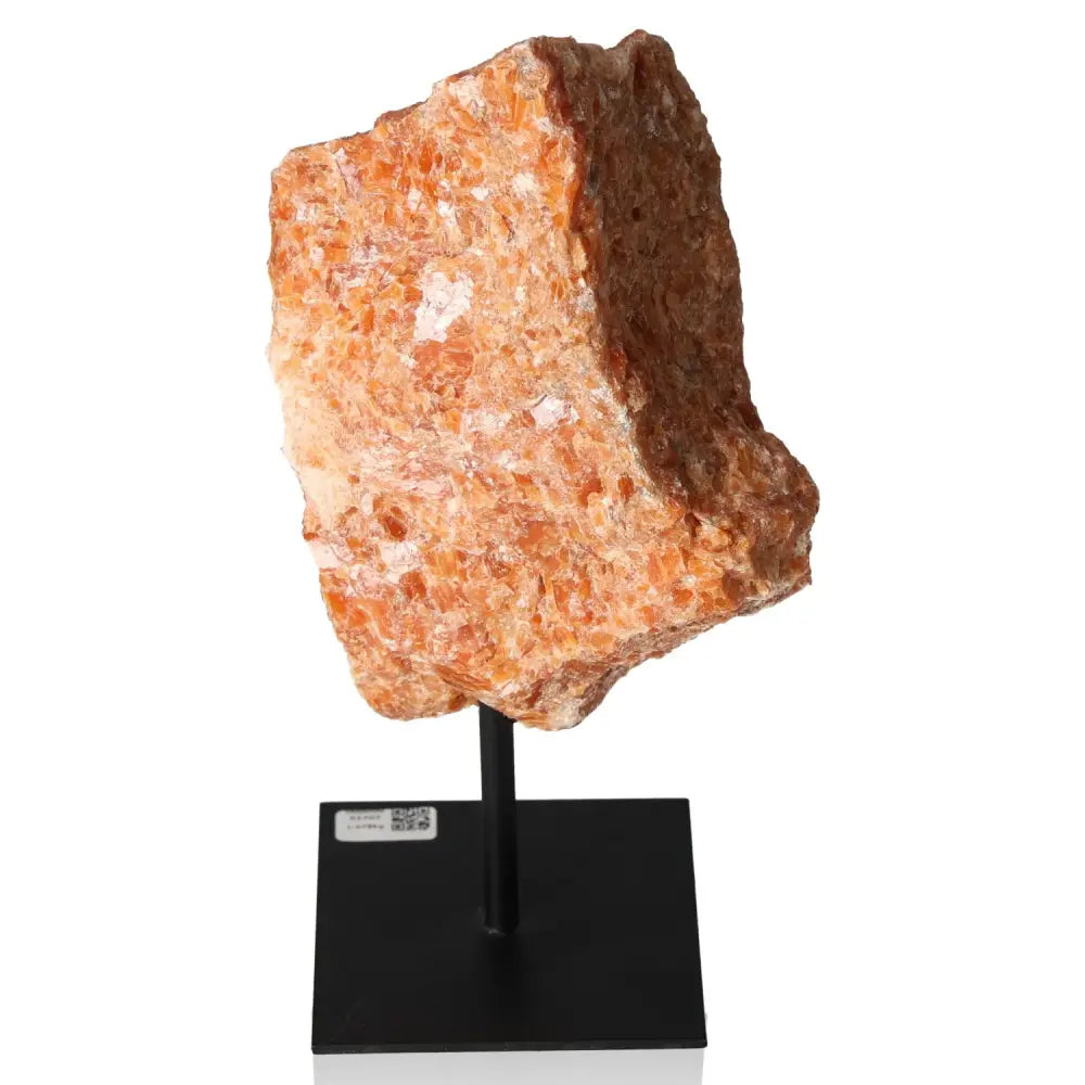 Orchid Calcite gemstone on metal stand, showcases vibrant orange and pink tones, symbolizing motivation and creativity.