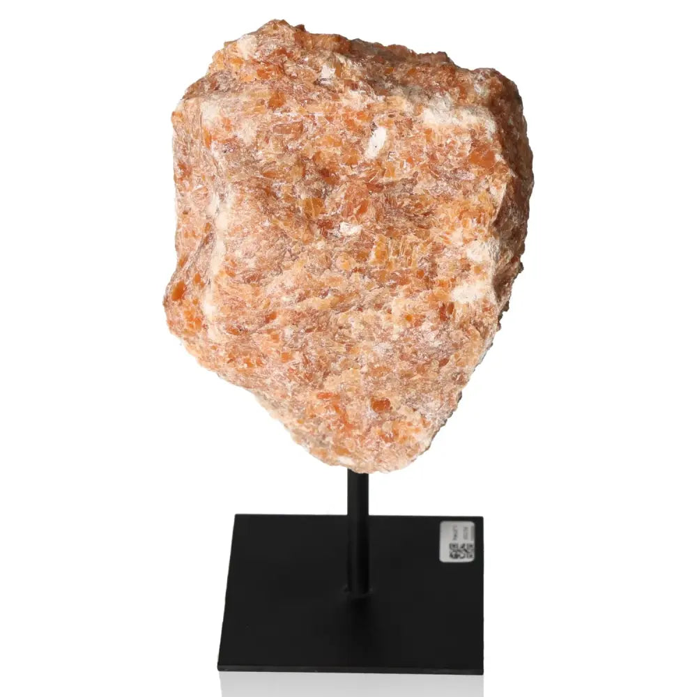 Orchid Calcite on metal stand showcasing vibrant orange and pink tones, symbolizing motivation and creativity for personal growth.