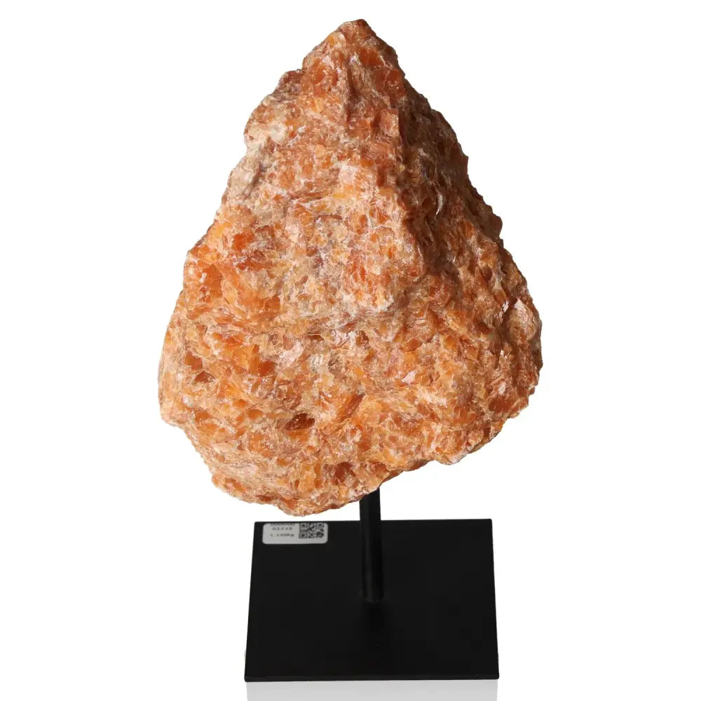 Orchid Calcite gemstone on metal stand, enhancing creativity and motivation with its vibrant orange and pink hues.