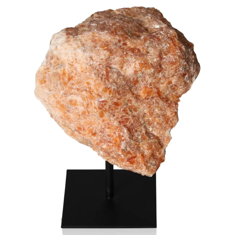 Orchid Calcite gemstone on metal stand, showcasing vibrant orange and pink hues for motivation, creativity, and emotional strength.