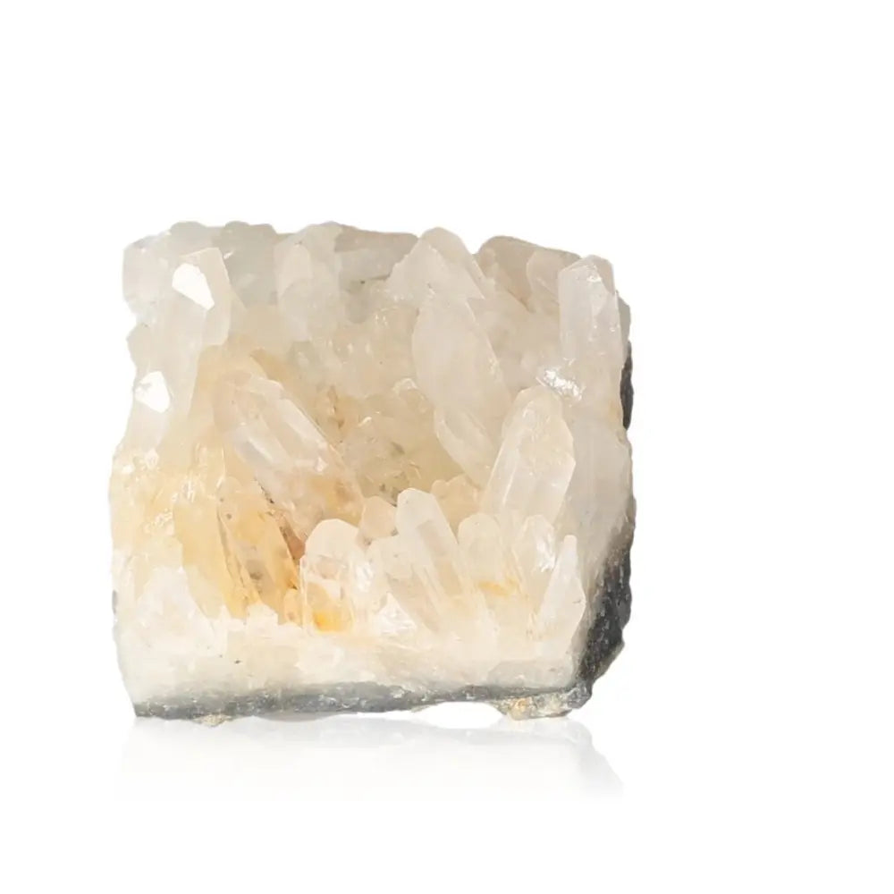 Multi-colored quartz crystal cluster on a reflective surface, showcasing a spectrum of enchanting colors and spiritual depth.