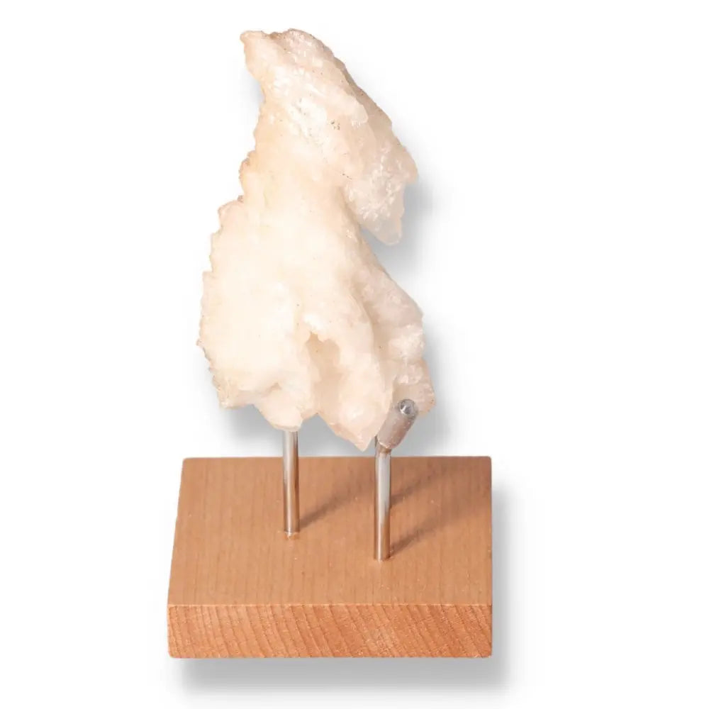 Decorative honey calcite gemstone on wooden stand, symbolizing confidence and clarity, perfect for enhancing focus and motivation.