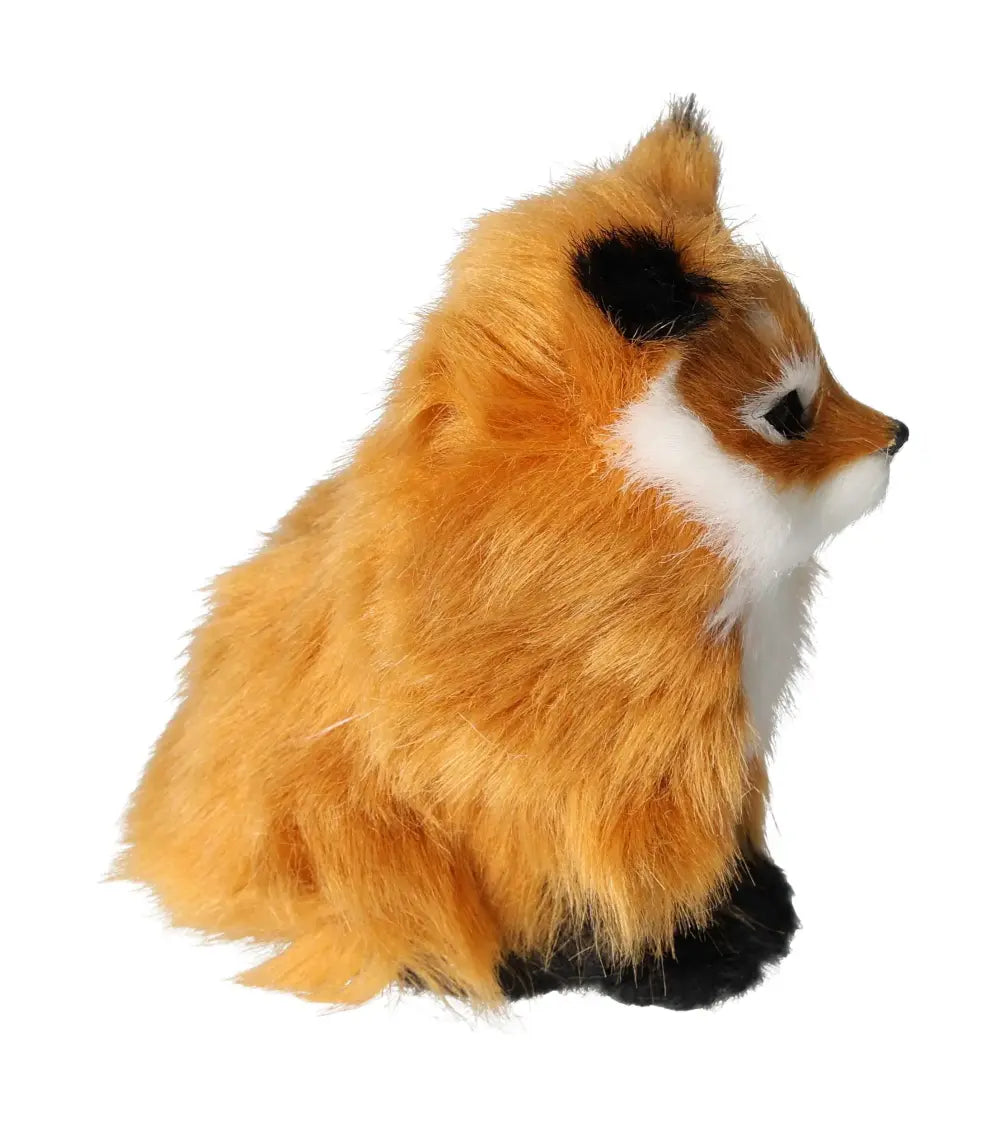 Side view of a plush, lifelike orange fox toy with realistic fur details, sitting upright against a white background.